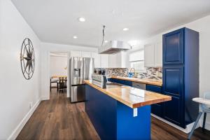 a kitchen with blue cabinets and a stainless steel refrigerator at Nookside Grand Estate For 8 in Hamilton