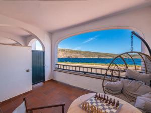 a living room with a view of the ocean at Els Tamarells Apartment by 3VILLAS in Fornells