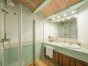 a bathroom with a glass shower and a sink at Els Tamarells Apartment by 3VILLAS in Fornells