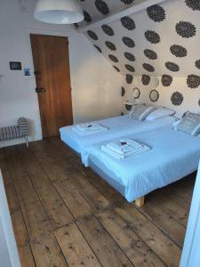 a bedroom with two beds and a wooden floor at Chambres d'hôtes Atypik in Dieppe