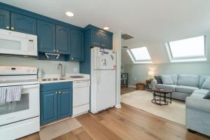 a kitchen with blue cabinets and a white refrigerator at Ocean City 2BR Condo in Ocean City