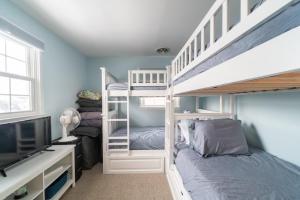 a bedroom with two bunk beds and a television at Ocean City 2BR Condo in Ocean City