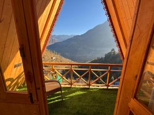 a view from the door of a cabin with a view of a mountain at The nature view A shaped tree cottage in Banjār