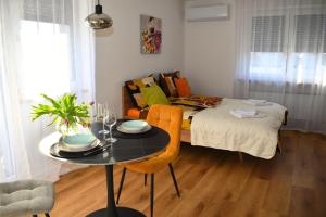 a room with a bed and a table and a couch at Ahat apartment- Modern stay near center & free parking in Maribor