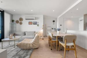 a living room with a table and a couch at 39th floor luxurious spacious apartment in Melbourne