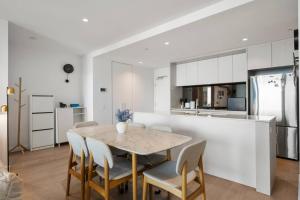 a kitchen and dining room with a table and chairs at 39th floor luxurious spacious apartment in Melbourne