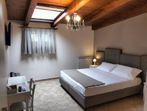 a bedroom with a bed and a chandelier at Bed & Breakfast De Nittis - Meridia Collection in Barletta +54 photos