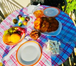 a table with plates of food on a table at Nena’s Dashe House in Berat