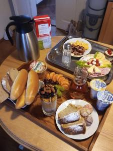 a tray of food on a table with plates of food at Zámek Nemilkov in Velhartice
