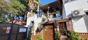 a house with a brown door and a fence at ENA Serenity Boutique Hotel Ephesus in Selçuk
