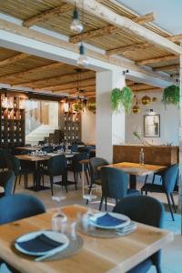 a dining room with wooden tables and chairs at SHAH Rooms&relax in Taranto