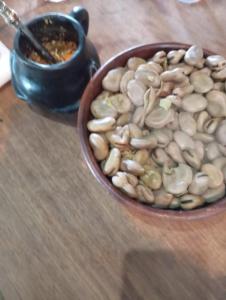 a bowl of nuts sitting on a wooden table at Ruka cabaña - Alojamiento Tradicional Mapuche in Temuco