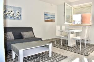 a living room with a couch and a table at Apartmani Cassiopeia in Murine