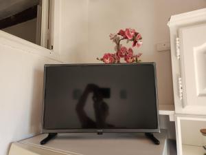 a television with a person taking a picture at French Cocoon in Fayence