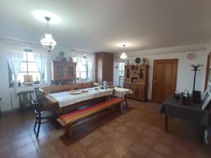 a large living room with a table and a kitchen at Kolonics Pincészet Vendégház Somló in Somlóvásárhely