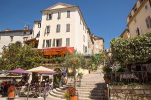 a group of people sitting at tables on the stairs of a building at French Cocoon in Fayence