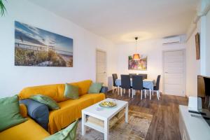 a living room with a couch and a table at El Nido in Gavà