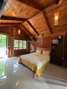 a bedroom with a bed in a room with wooden ceilings at Nature retreat in Río Cuarto
