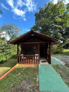 a small wooden building with a green walkway at Nature retreat in Río Cuarto