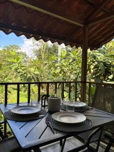 a wooden table with two plates on top of it at Nature retreat in Río Cuarto