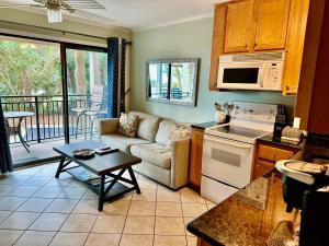 a kitchen and living room with a couch and a table at Seaside 190 in Hilton Head Island