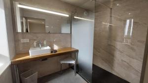 a bathroom with a sink and a shower at Létable de Boissadel in Boisset +14 photos