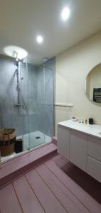a bathroom with a glass shower and a sink at Maison PARAGONE in Bergues +16 photos