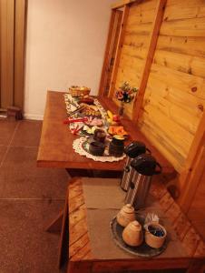 a wooden table with food on top of it at Pousada Zacarias in Ouro Preto