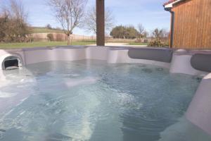 a jacuzzi tub in a backyard at LE DOMAINE DES SENS - Chalet avec SPA privatif - pleine nature - expérience détente in Hans