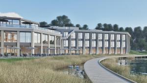 a large building with a wooden walkway next to a lake at Postillion Hotel Breda Biesbosch in Raamsdonksveer