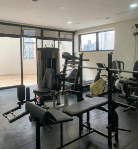 a gym with lots of exercise equipment in a room at Bienal Suítes in São Paulo