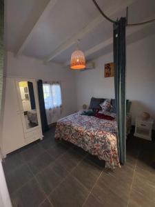 a bedroom with a bed and a chandelier at Habitations Amédée in Bouillante