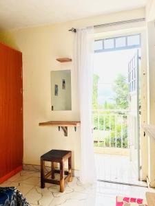 a room with a large window and a table at Zion Homes in Taveta