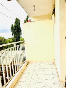 a balcony of a house with a white wall at Zion Homes in Taveta
