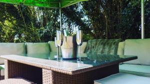 a table with two wine glasses on a patio at Grand bubble in Kent