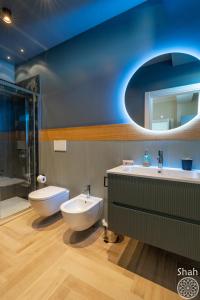 a bathroom with a sink and a toilet and a mirror at SHAH Rooms&relax in Taranto +35 photos