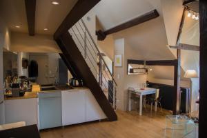 a kitchen with a staircase leading up to a loft at Loft Altavista in Talloires