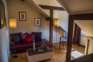 a living room with a couch and a table at Loft Altavista in Talloires +2 photos