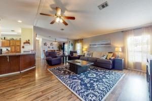 a living room with a couch and a ceiling fan at Boat Dock! 'Sunshine House' on St. Johns River in Astor