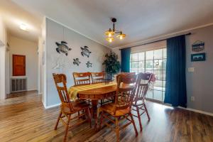 a dining room with a wooden table and chairs at Boat Dock! 'Sunshine House' on St. Johns River in Astor +13 photos