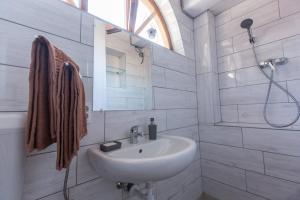 a white bathroom with a sink and a shower at Mandulaág Vendégház in Egerszalók +62 photos