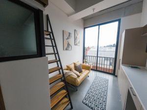 a living room with a flat screen tv and a couch at Atom Cuatro 303 in Guatemala