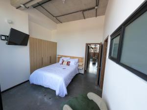 a bedroom with a bed and a large window at Atom Cuatro 303 in Guatemala