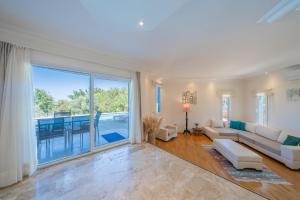 a living room with a couch and a large window at Lacitrus Hotel & Villa in Kaş +113 photos
