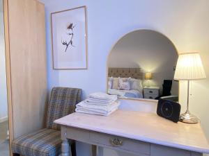 a bedroom with a bed and a table with a mirror at Hidden Gem in a great location very near Isle of Skye in Kyle of Lochalsh