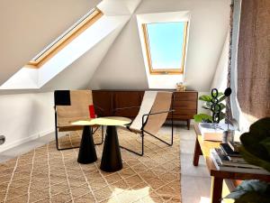 a room with a table and chairs in a attic at Premium Design Loft - Old Town in Košice