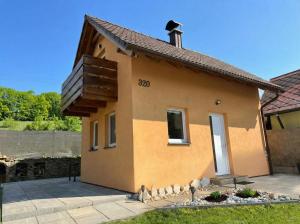 a small house with a number on the side of it at Chalet U Pstruha in Vimperk