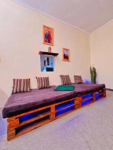 a large bed in a room with a purple mattress at Makao Home in Arusha