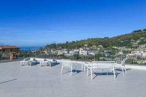 a group of white chairs and tables on a roof at Casa Saveria in Massa Lubrense