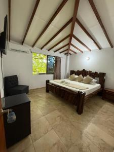 a bedroom with a large bed in a room at Hotel Santorini Doradal in Doradal